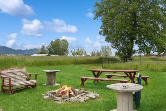 65637 Mt Highway 37, Eureka, MT 59917 - surrounding community with an outdoor fire pit, a lawn, a mountain view, and a view of countryside