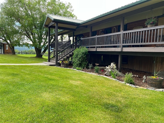 65637 Mt Highway 37, Eureka, MT 59917 - view of side of home featuring a lawn, a metal roof, and stairs