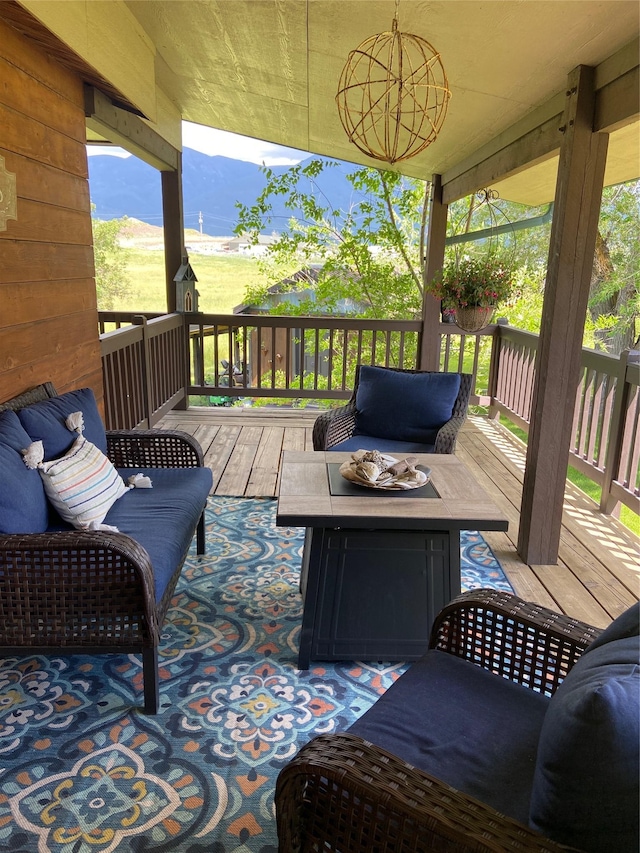 65637 Mt Highway 37, Eureka, MT 59917 - wooden deck featuring an outdoor living space with a fire pit and a mountain view