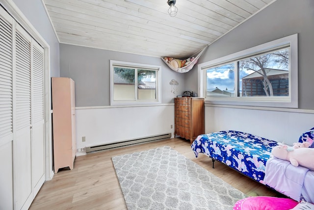 bedroom with lofted ceiling, a baseboard radiator, light wood-style flooring, wood ceiling, and a closet