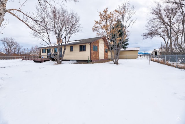 view of front of house with fence and a wooden deck