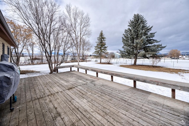 snow covered deck with fence