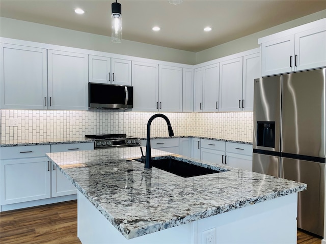 kitchen featuring stainless steel appliances, dark wood-type flooring, a sink, and light stone countertops