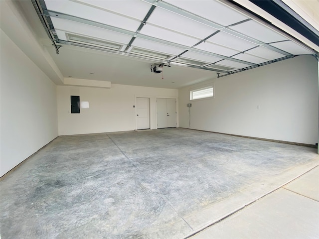 garage featuring electric panel and a garage door opener