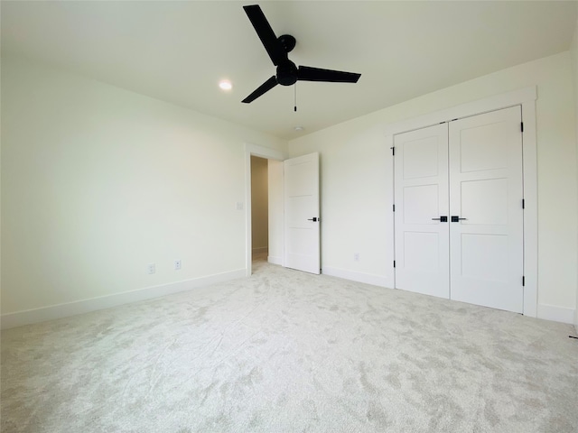 unfurnished bedroom featuring carpet floors, a closet, a ceiling fan, and baseboards