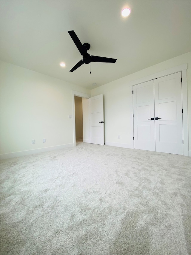 unfurnished bedroom featuring baseboards, a ceiling fan, light colored carpet, a closet, and recessed lighting