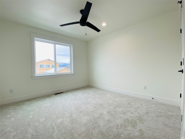 carpeted empty room with ceiling fan, recessed lighting, visible vents, and baseboards