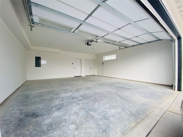 garage with electric panel and a garage door opener