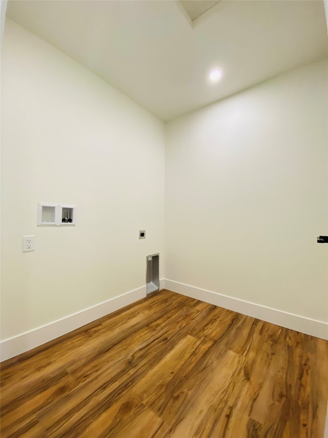 laundry room featuring laundry area, baseboards, wood finished floors, hookup for a washing machine, and electric dryer hookup