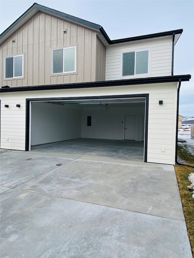 exterior space featuring concrete driveway and an attached garage