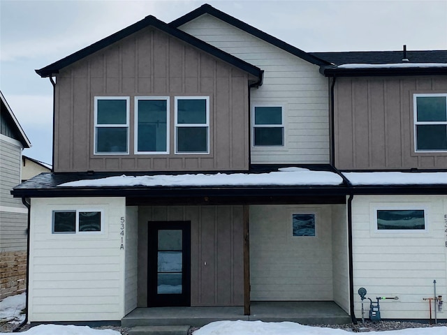 view of front of home with covered porch, a shingled roof, and board and batten siding