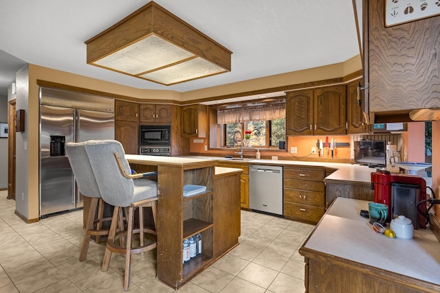 kitchen with a center island, light tile patterned floors, open shelves, a sink, and built in appliances