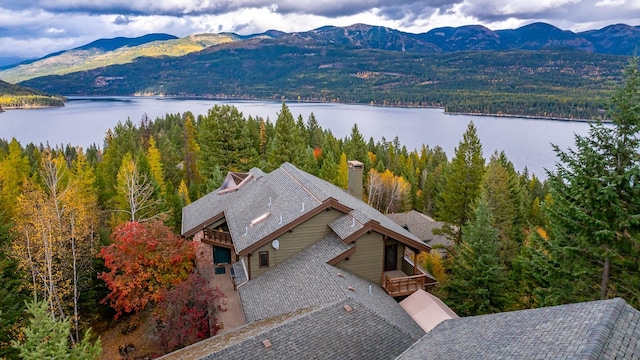 birds eye view of property with a forest view and a water and mountain view