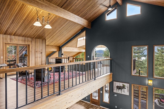 interior space with high vaulted ceiling, wood ceiling, beam ceiling, and wood finished floors