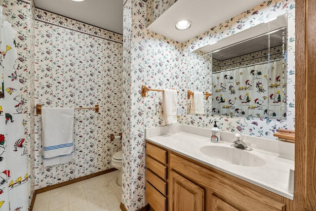 bathroom featuring tile patterned floors, vanity, toilet, and wallpapered walls