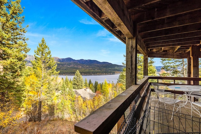 balcony featuring a water and mountain view