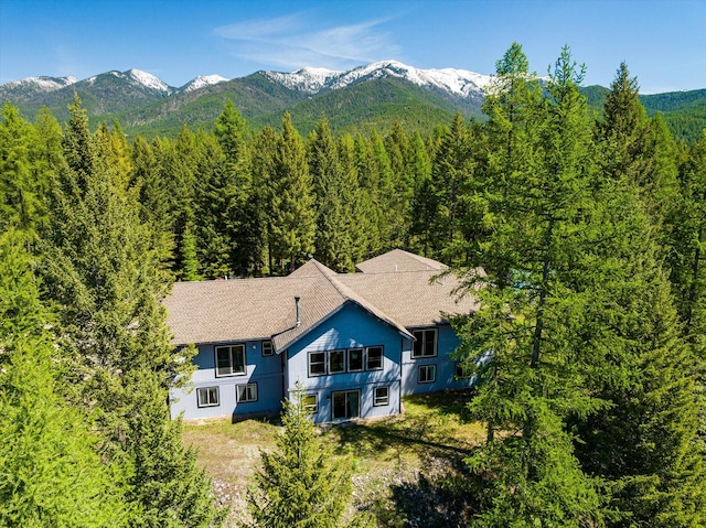 aerial view with a mountain view and a forest view