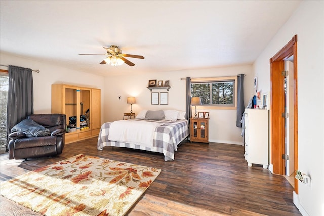 bedroom with dark wood-type flooring, multiple windows, ceiling fan, and baseboards