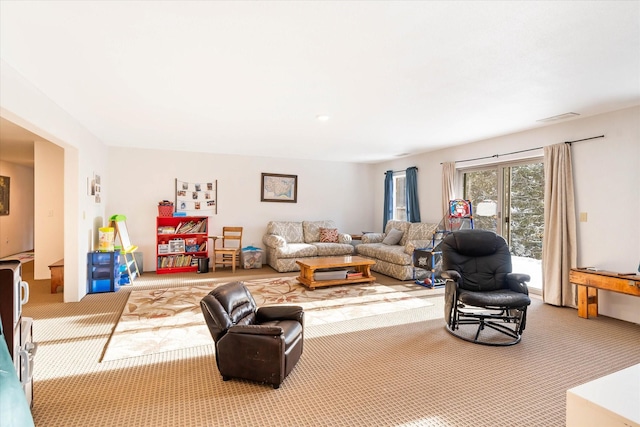 carpeted living area featuring visible vents