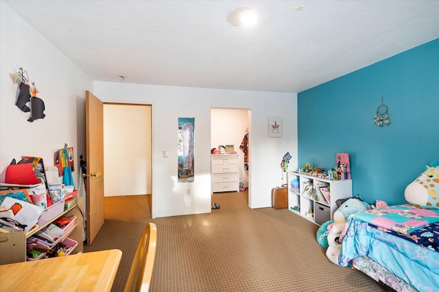 carpeted bedroom featuring a closet and a spacious closet