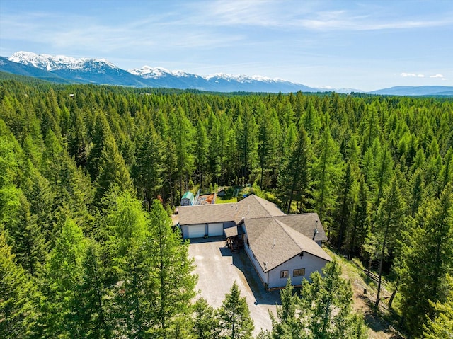 birds eye view of property featuring a mountain view and a forest view