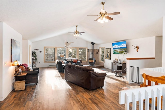 living room with lofted ceiling, ceiling fan, a baseboard heating unit, wood finished floors, and a wood stove