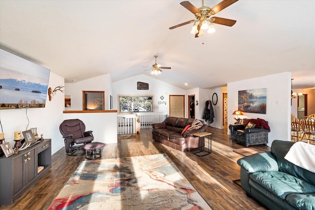 living room featuring lofted ceiling, an inviting chandelier, and wood finished floors