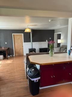 155 8th Ave, Kalispell, MT 59901 - kitchen featuring wood finished floors, a fireplace, and light countertops