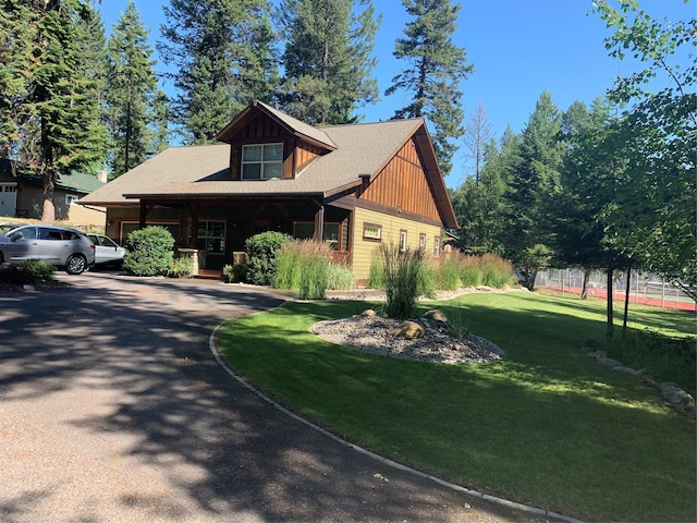 view of front of house with driveway and a front lawn