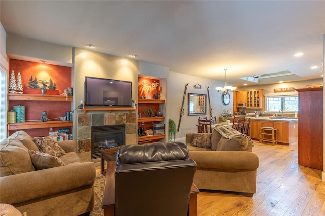935 Pack Rat Ln, Whitefish, MT 59937 - living area featuring a chandelier, light wood finished floors, a tile fireplace, and recessed lighting