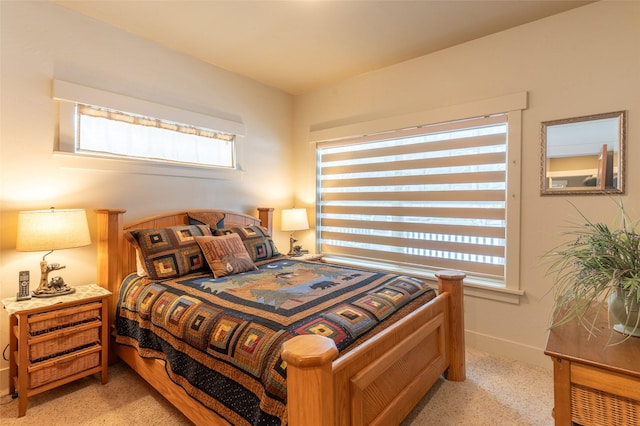 935 Pack Rat Ln, Whitefish, MT 59937 - bedroom with multiple windows, light colored carpet, and baseboards