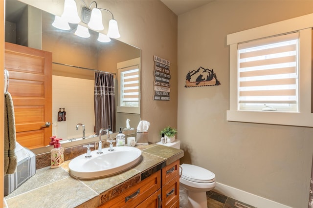 935 Pack Rat Ln, Whitefish, MT 59937 - full bathroom with a chandelier, toilet, vanity, a shower with curtain, and baseboards