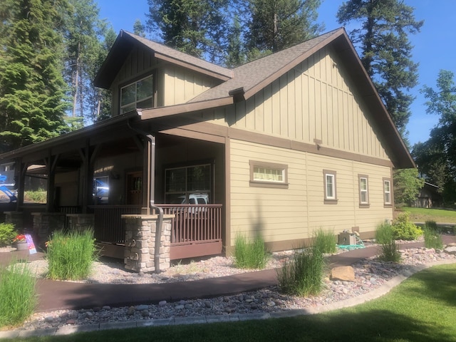 935 Pack Rat Ln, Whitefish, MT 59937 - view of property exterior featuring covered porch, board and batten siding, and a shingled roof