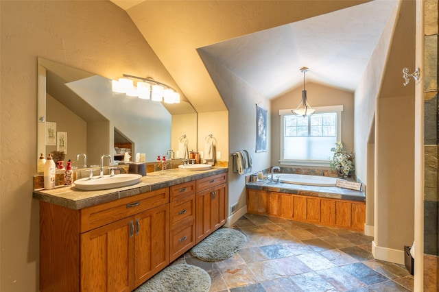 935 Pack Rat Ln, Whitefish, MT 59937 - full bathroom with stone tile floors, double vanity, vaulted ceiling, a bath, and baseboards