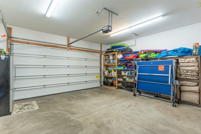 935 Pack Rat Ln, Whitefish, MT 59937 - garage featuring freestanding refrigerator and a garage door opener