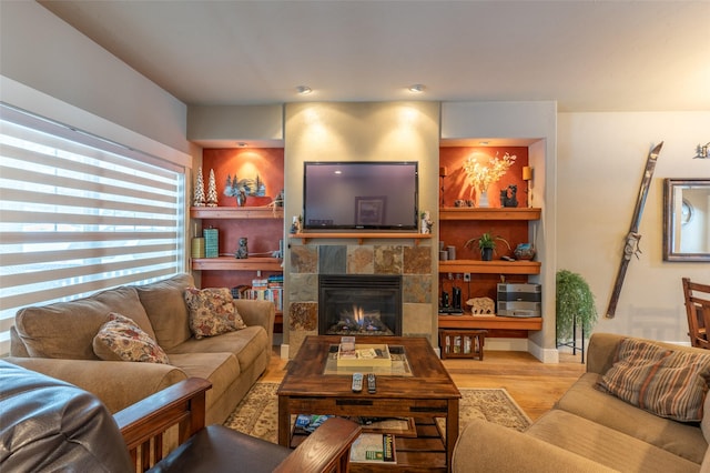 935 Pack Rat Ln, Whitefish, MT 59937 - living area featuring wood finished floors, a tiled fireplace, and baseboards