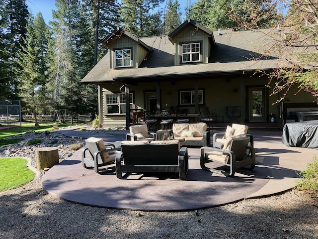 935 Pack Rat Ln, Whitefish, MT 59937 - rear view of house featuring an outdoor living space, a patio area, and roof with shingles