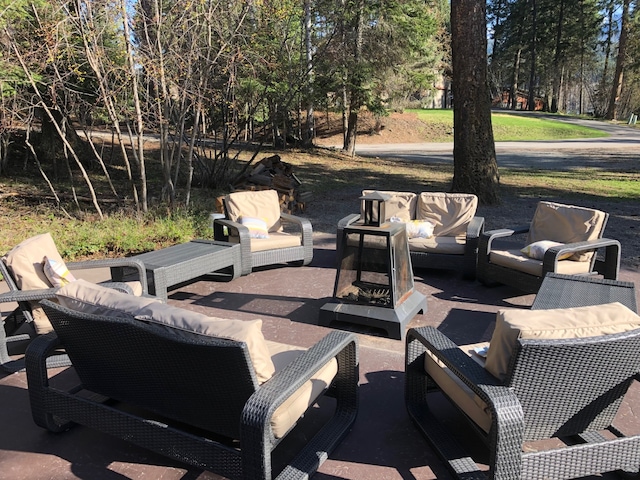 935 Pack Rat Ln, Whitefish, MT 59937 - view of patio featuring an outdoor living space and view of wooded area