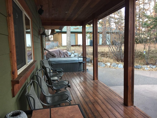 935 Pack Rat Ln, Whitefish, MT 59937 - deck with a jacuzzi, an outbuilding, and a patio area