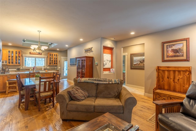 935 Pack Rat Ln, Whitefish, MT 59937 - living room featuring light wood-style floors, a chandelier, recessed lighting, and baseboards