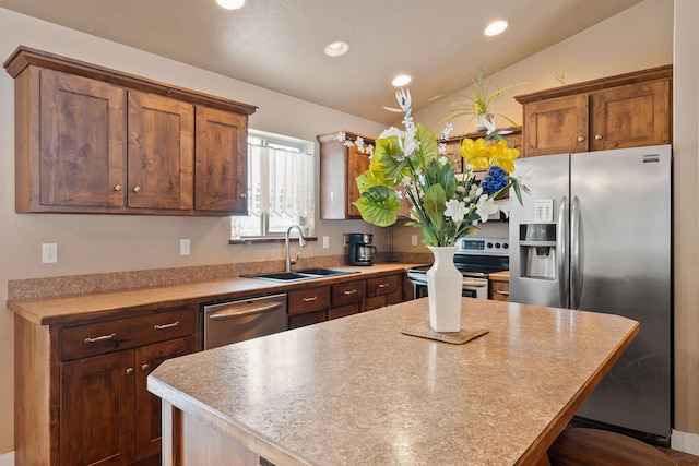 kitchen featuring recessed lighting, appliances with stainless steel finishes, vaulted ceiling, a sink, and a kitchen island