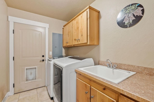 laundry area featuring washing machine and clothes dryer, cabinet space, light tile patterned flooring, a sink, and electric panel