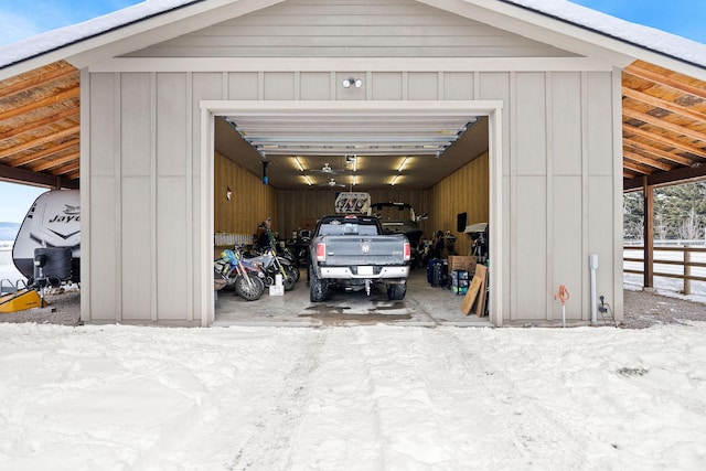 detached garage featuring fence