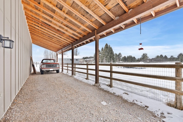 snow covered patio featuring a carport