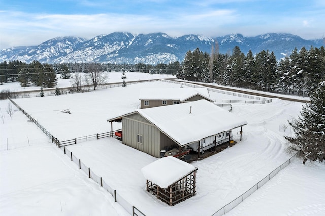 snowy aerial view featuring a mountain view