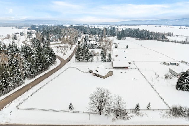 snowy aerial view with a mountain view