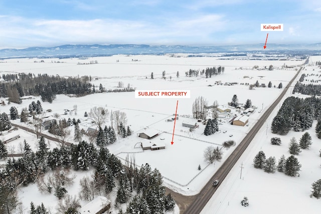 snowy aerial view with a mountain view