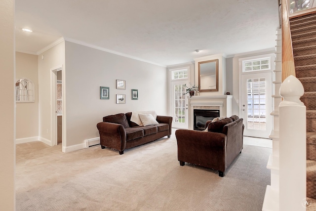 living room with baseboards, a glass covered fireplace, light colored carpet, stairs, and crown molding