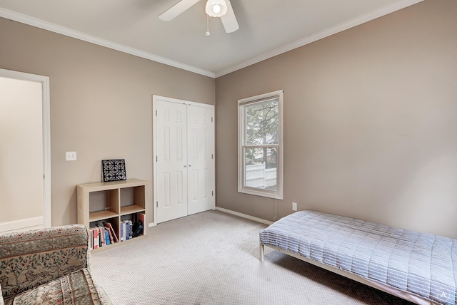 bedroom with a ceiling fan, baseboards, a closet, carpet, and crown molding