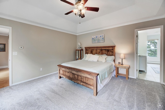 bedroom with light colored carpet, a baseboard heating unit, baseboards, ornamental molding, and a tray ceiling